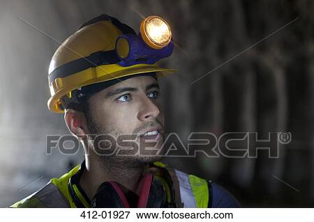 Stock Photo - Worker standing in tunnel. Fotosearch