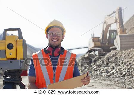 Worker using leveling equipment in quarry View Large Photo Image Stock Photo - Worker using leveling equipment in quarry. Fotosearch