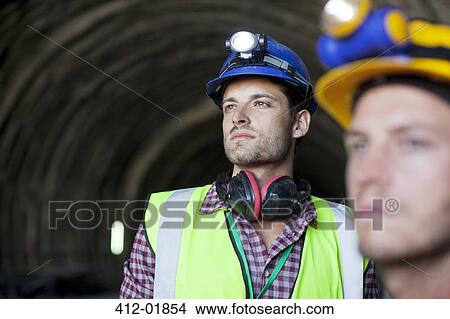Workers looking out from tunnel View Large Photo Image Picture - Workers looking out from tunnel. Fotosearch