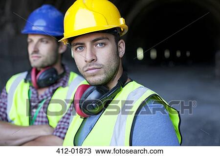 Workers looking out from tunnel View Large Photo Image Stock Image - Workers looking out from tunnel. Fotosearch