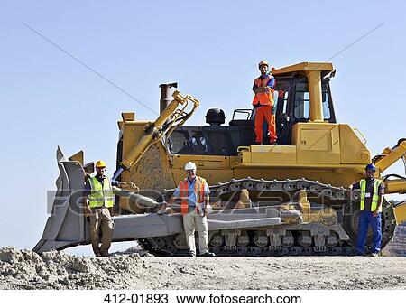 Workers on bulldozer smiling in quarry View Large Photo Image Stock Image - Workers on bulldozer smiling in quarry. Fotosearch