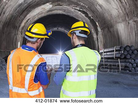 Workers reading blueprints in tunnel View Large Photo Image Picture - Workers reading blueprints in tunnel. Fotosearch