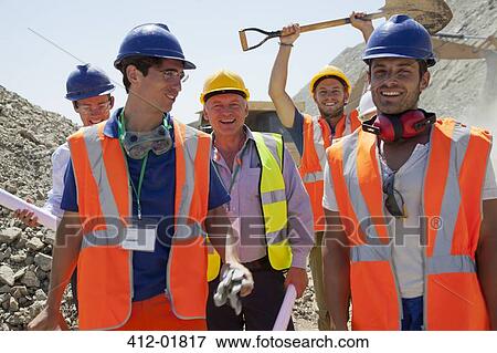 Workers smiling together in quarry View Large Photo Image Stock Photo - Workers smiling together in quarry. Fotosearch