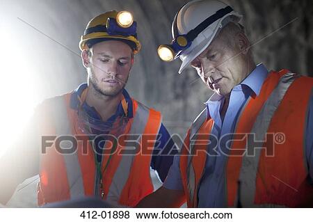 Workers talking in tunnel View Large Photo Image Stock Photo - Workers talking in tunnel. Fotosearch