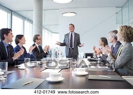 Business people applauding colleague in meeting View Large Photo Image Stock Photo - Business people applauding colleague in meeting. Fotosearch