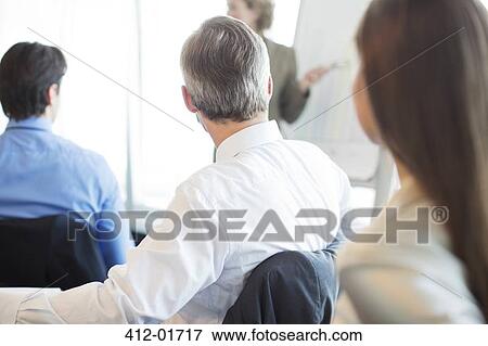 Business people sitting in meeting View Large Photo Image Stock Photo - Business people sitting in meeting. Fotosearch