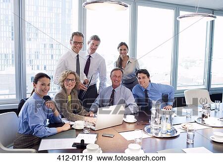 Stock Photo - Business people smiling in meeting. Fotosearch