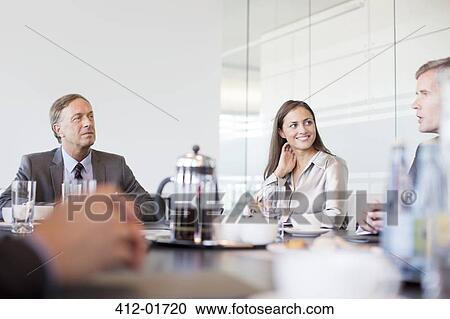 Stock Image - Business people talking in meeting. Fotosearch