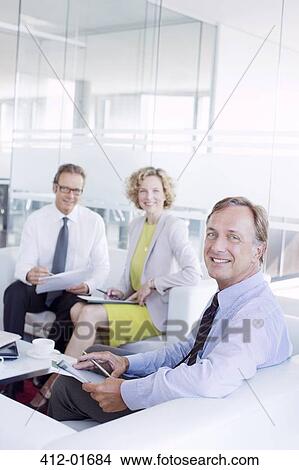 Business people talking in office lobby area View Large Photo Image Picture - Business people talking in office lobby area. Fotosearch