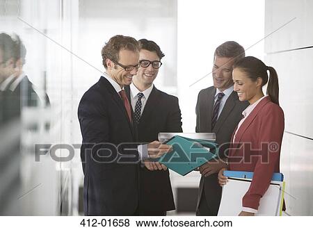 Business people talking in office hallway View Large Photo Image Stock Photo - Business people talking in office hallway. Fotosearch