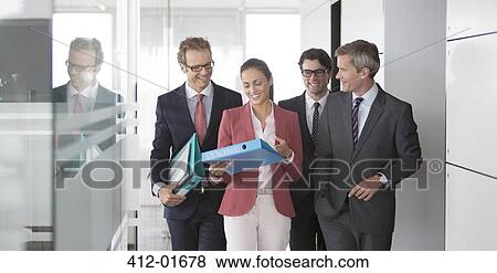 Business people talking in office hallway View Large Photo Image Stock Photo - Business people talking in office hallway. Fotosearch