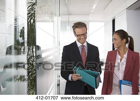 Stock Photo - Business people talking in office hallway. Fotosearch