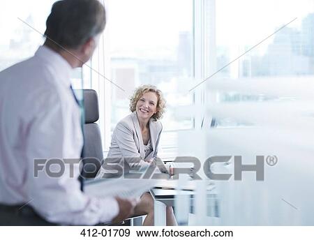 Stock Photo - Business people talking in office. Fotosearch