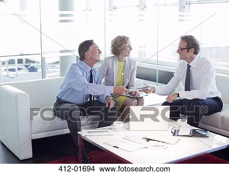 Business people talking office lobby area View Large Photo Image Picture - Business people talking office lobby area. Fotosearch