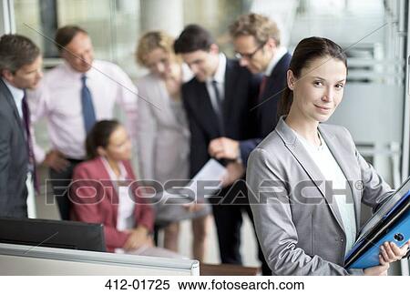 Stock Photography - Business woman smiling in office. Fotosearch