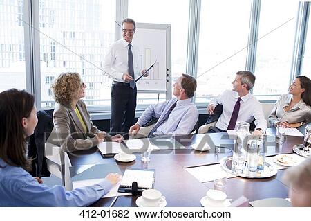 Stock Image - Businessman talking in meeting. Fotosearch