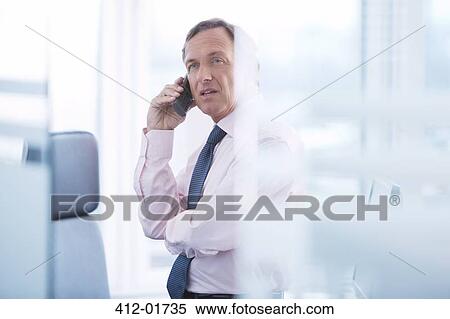 Businessman talking on cell phone View Large Photo Image Stock Photography - Businessman talking on cell phone. Fotosearch