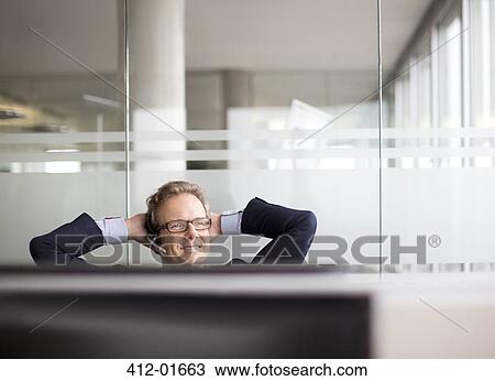 Businessman talking on headset in office View Large Photo Image Stock Image - Businessman talking on headset in office. Fotosearch