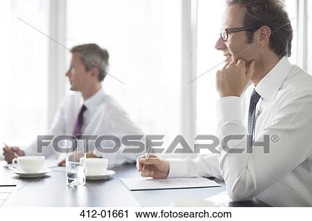 Businessmen sitting in meeting View Large Photo Image Stock Image - Businessmen sitting in meeting. Fotosearch