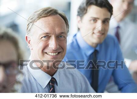 Stock Photograph - Businessmen smiling in meeting. Fotosearch