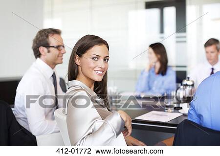 Businesswoman smiling in meeting View Large Photo Image Stock Image - Businesswoman smiling in meeting. Fotosearch