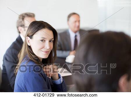 Businesswoman smiling in meeting View Large Photo Image Stock Photo - Businesswoman smiling in meeting. Fotosearch