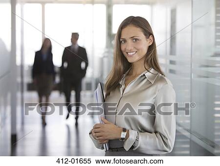 Businesswoman smiling in office View Large Photo Image Stock Photography - Businesswoman smiling in office. Fotosearch