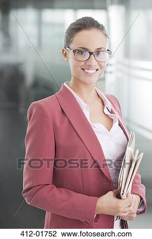 Businesswoman standing in office hallway View Large Photo Image Stock Image - Businesswoman standing in office hallway. Fotosearch