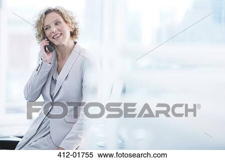 Businesswoman talking on phone in office View Large Photo Image Stock Photography - Businesswoman talking on phone in office. Fotosearch