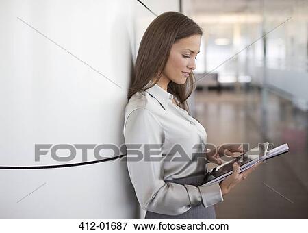 Businesswoman using digital tablet in office View Large Photo Image Stock Photo - Businesswoman using digital tablet in office. Fotosearch