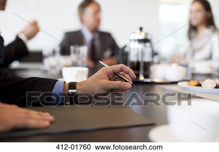 Close up of businessman's hand in meeting View Large Photo Image Stock Image - Close up of businessman's hand in meeting. Fotosearch