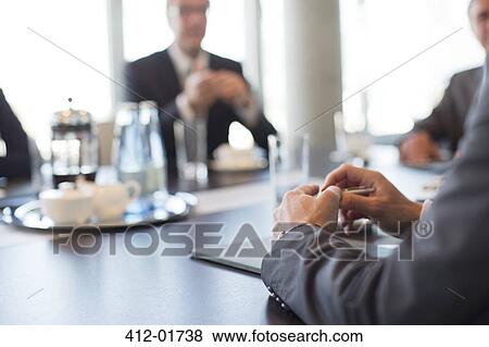 Close up of businessman's hands in meeting View Large Photo Image Stock Photo - Close up of businessman's hands in meeting. Fotosearch