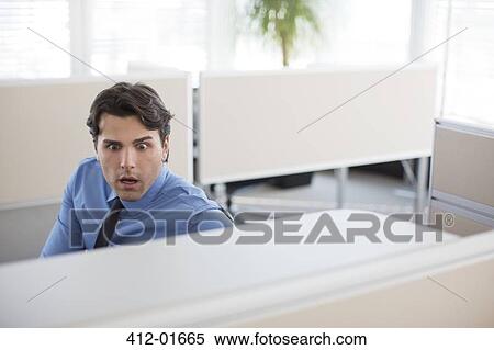 Surprised businessman working in office View Large Photo Image Stock Photography - Surprised businessman working in office. Fotosearch