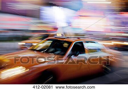 Blurred view of taxi on city street at night View Large Photo Image Stock Image - Blurred view of taxi on city street at night. Fotosearch