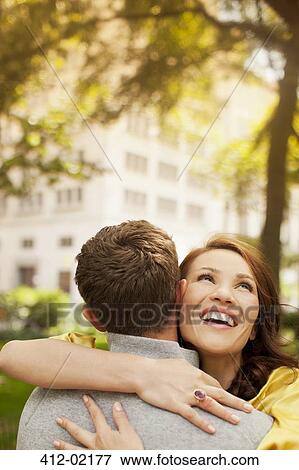 Couple hugging in urban park View Large Photo Image Stock Photo - Couple hugging in urban park. Fotosearch