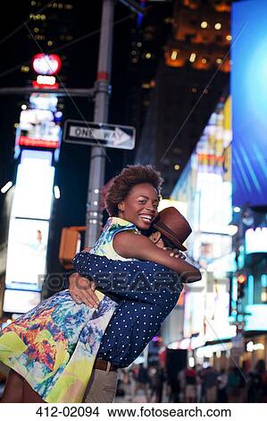 Couple hugging on city street at night View Large Photo Image Picture - Couple hugging on city street at night. Fotosearch