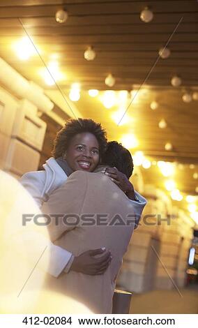 Couple hugging on city street View Large Photo Image Picture - Couple hugging on city street. Fotosearch