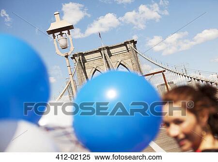 Couple with balloon walking on urban bridge View Large Photo Image Stock Photography - Couple with balloon walking on urban bridge. Fotosearch