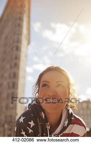 Stock Photograph - Smiling woman on city street. Fotosearch