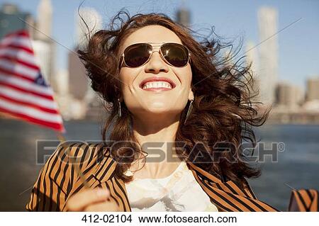 Smiling woman waving American flag View Large Photo Image Picture - Smiling woman waving American flag. Fotosearch