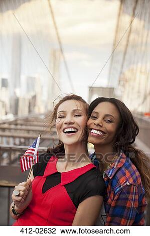 Smiling women waving American flag View Large Photo Image Stock Image - Smiling women waving American flag. Fotosearch
