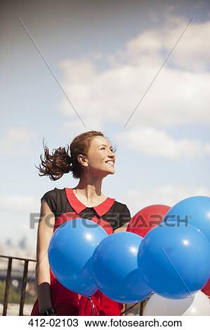 Woman carrying bunch of balloons View Large Photo Image Stock Image - Woman carrying bunch of balloons. Fotosearch