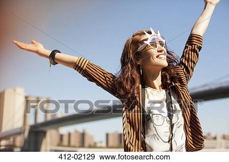 Woman in novelty sunglasses standing by urban bridge View Large Photo Image Stock Photo - Woman in novelty sunglasses standing by urban bridge. Fotosearch