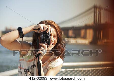 Woman taking picture by city cityscape View Large Photo Image Stock Image - Woman taking picture by city cityscape. Fotosearch