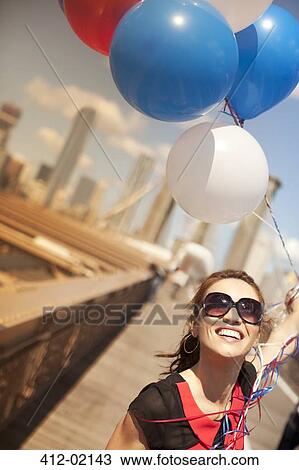 Woman with bunch of balloons on urban bridge View Large Photo Image Stock Image - Woman with bunch of balloons on urban bridge. Fotosearch
