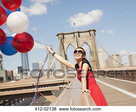 Woman with bunch of balloons on urban bridge View Large Photo Image Stock Photo - Woman with bunch of balloons on urban bridge. Fotosearch
