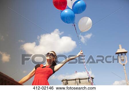 Woman with bunch of balloons on urban bridge View Large Photo Image Stock Photograph - Woman with bunch of balloons on urban bridge. Fotosearch