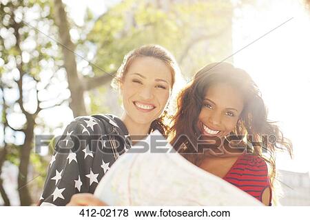 Women reading map outdoors View Large Photo Image Stock Photo - Women reading map outdoors. Fotosearch