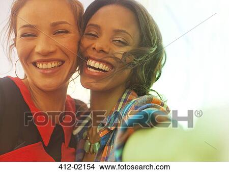 Women smiling together outdoors View Large Photo Image Picture - Women smiling together outdoors. Fotosearch