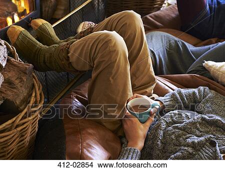 Boy drinking cup of coffee by fire View Large Photo Image Picture - Boy drinking cup of coffee by fire. Fotosearch